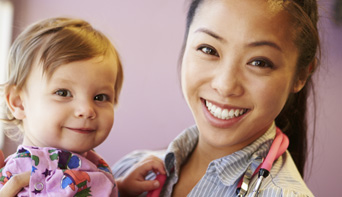 Doctor holding little girl